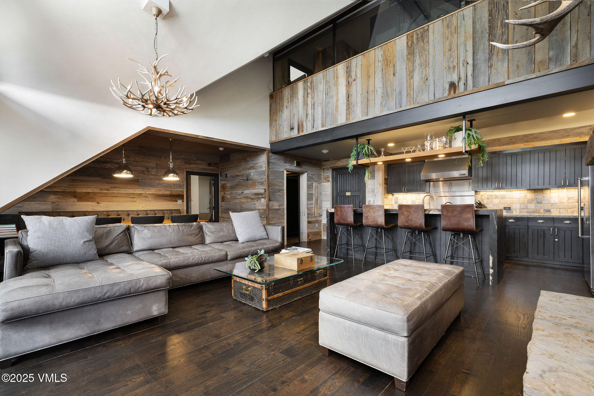 180 Daybreak Ridge Road, Unit 711 Beaver Creek, CO 81620 - Photo 3 of 17 a living room with furniture a chandelier and a fireplace