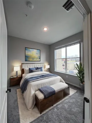 a bedroom with a large bed and a large window