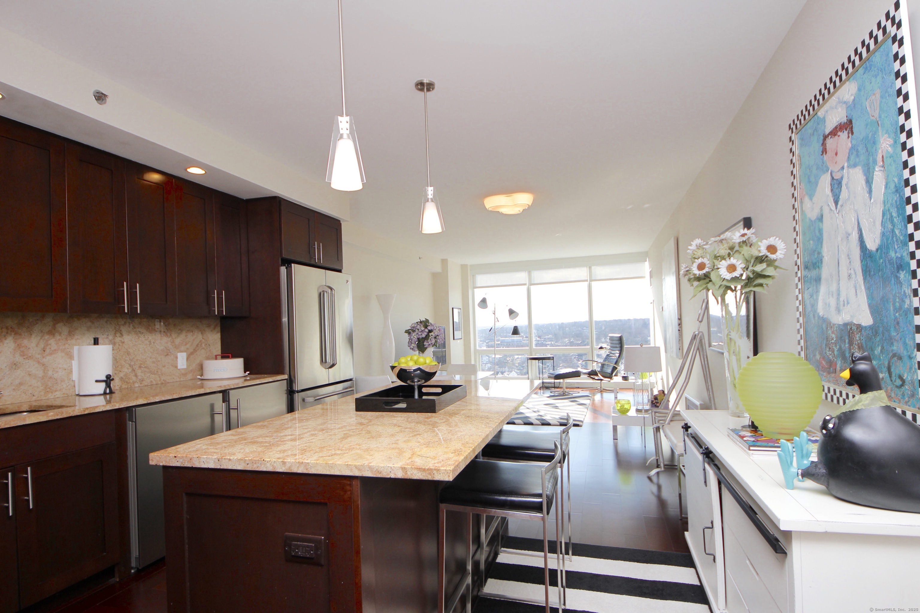 1 Broad Street, Unit 17C Stamford, CT 06901 - Photo 4 of 21 a kitchen with a table chairs sink and cabinets