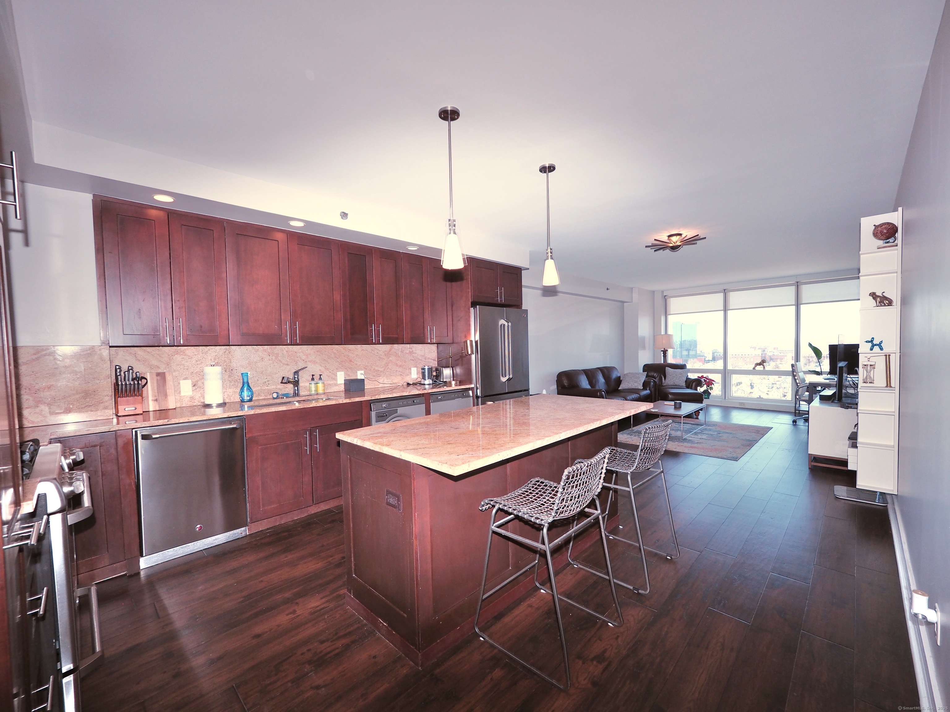 1 Broad Street, Unit 17C Stamford, CT 06901 - Photo 5 of 21 a kitchen with a table chairs sink and wooden floor