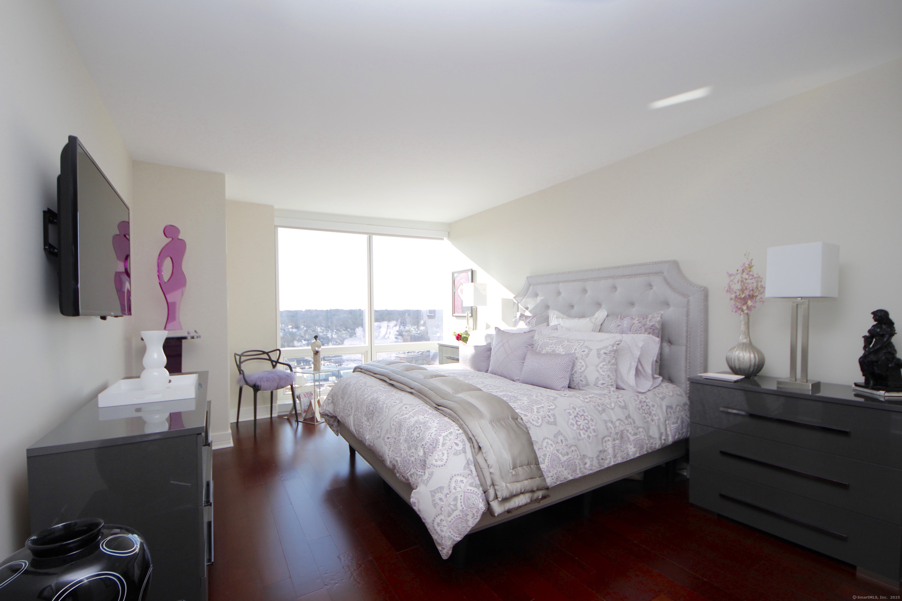 1 Broad Street, Unit 17C Stamford, CT 06901 - Photo 6 of 21 a bedroom with a bed and wooden floor