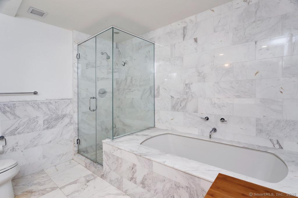 1 Broad Street, Unit 17C Stamford, CT 06901 - Photo 7 of 21 a bathroom with a bathtub and a shower