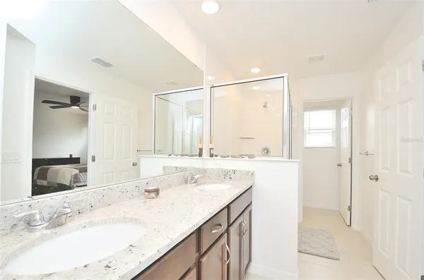 a bathroom with a granite countertop sink mirror and double