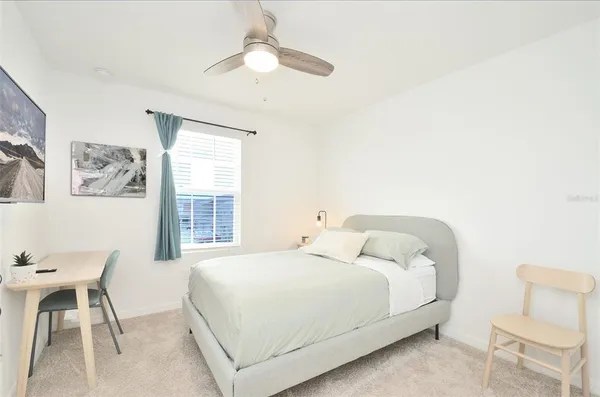 a bedroom with a bed and a table