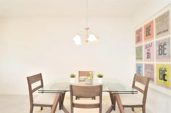 a view of a dining room with furniture and a potted plant