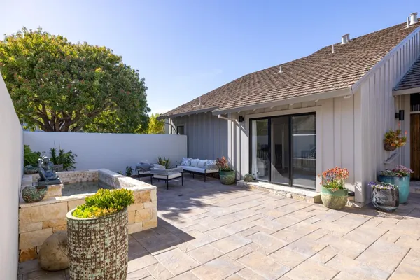 a backyard of a house with outdoor seating