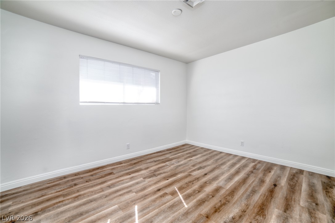 3556 Ruth Drive Las Vegas, NV 89121 - Photo 12 of 21 A well-lit bedroom with fresh finishes and durable flooring, ready for personalization.