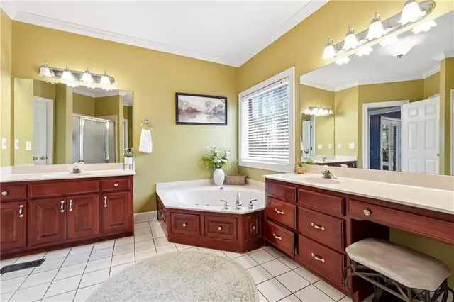 a bedroom with a bed chandelier and a window