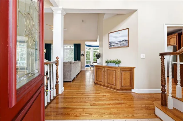 a view of an entryway with wooden floor and a livingroom view