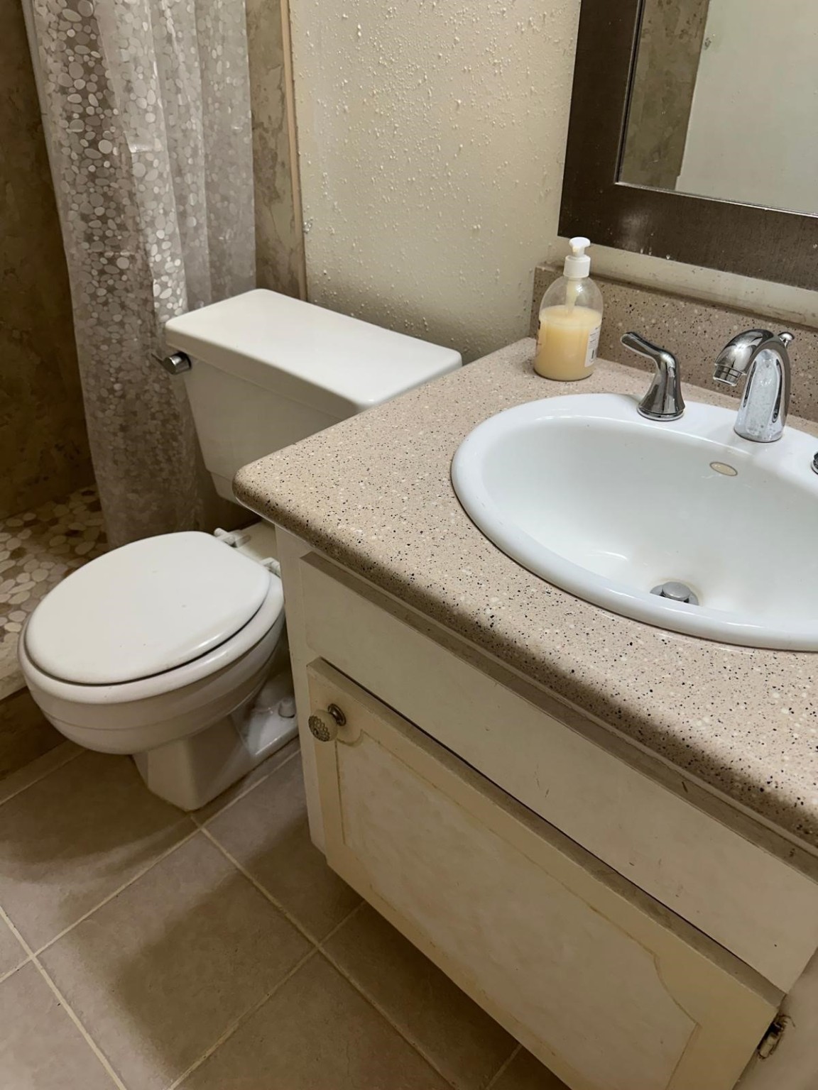 6410 Del Monte Drive, Unit 114 Houston, TX 77057 - Photo 13 of 27 a bathroom with a granite countertop toilet sink and mirror