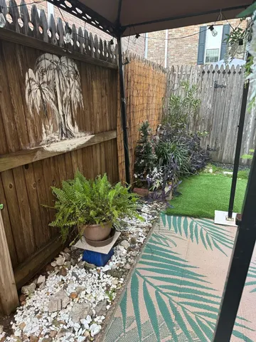 a view of a balcony with chair and potted plants