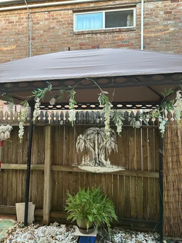 a front view of a building with a garden