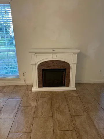 a view of empty room with a fireplace