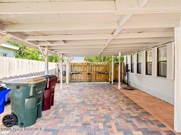 608 Indiana Avenue St. Cloud, FL 34769 - Photo 14 of 20 a view of a patio with table and chairs under an umbrella with a small yard