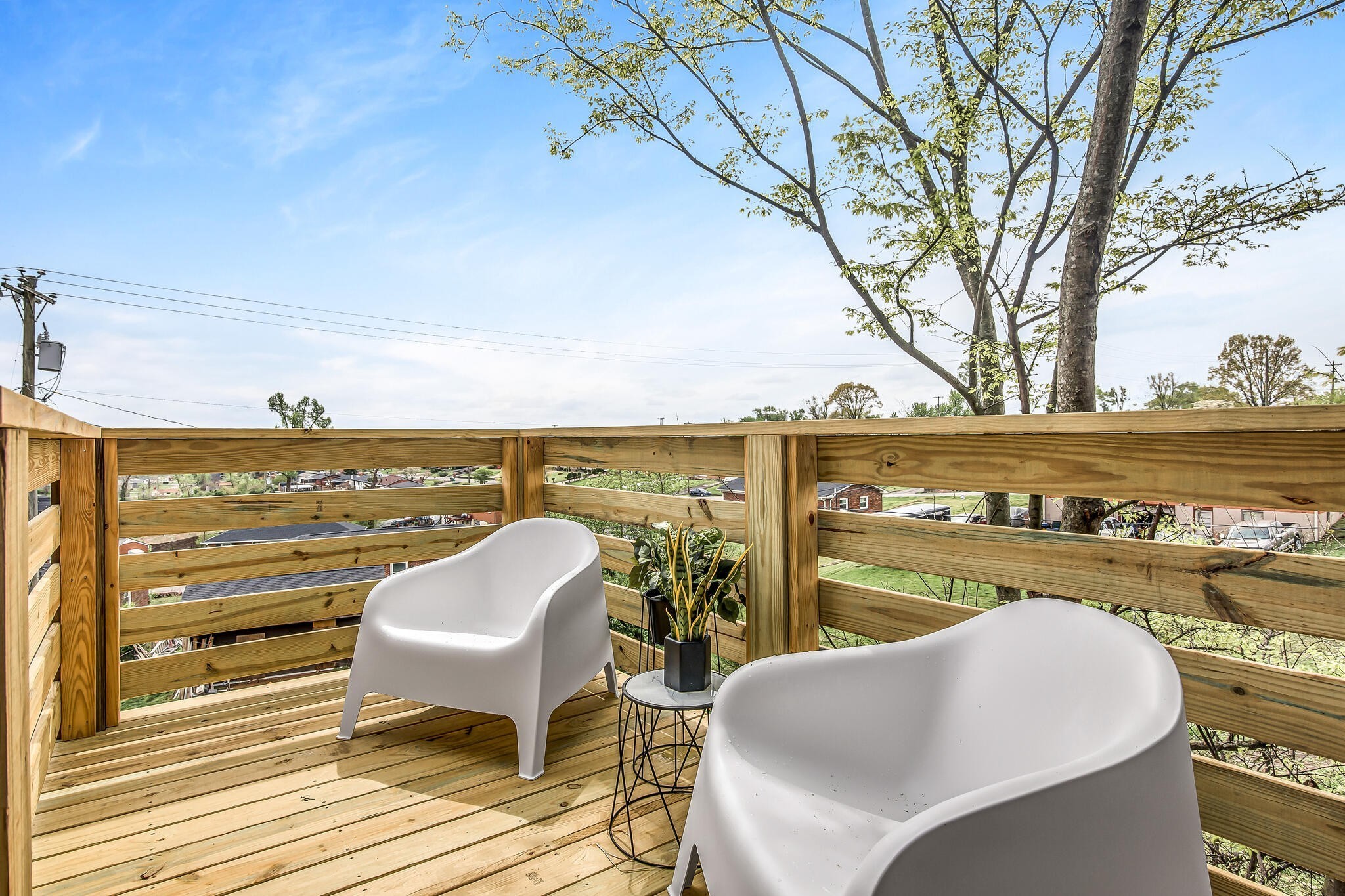 263 Riverside Drive, Unit A Nashville, TN 37206 - Photo 16 of 42 a view of a chairs and table on wooden deck with lake view