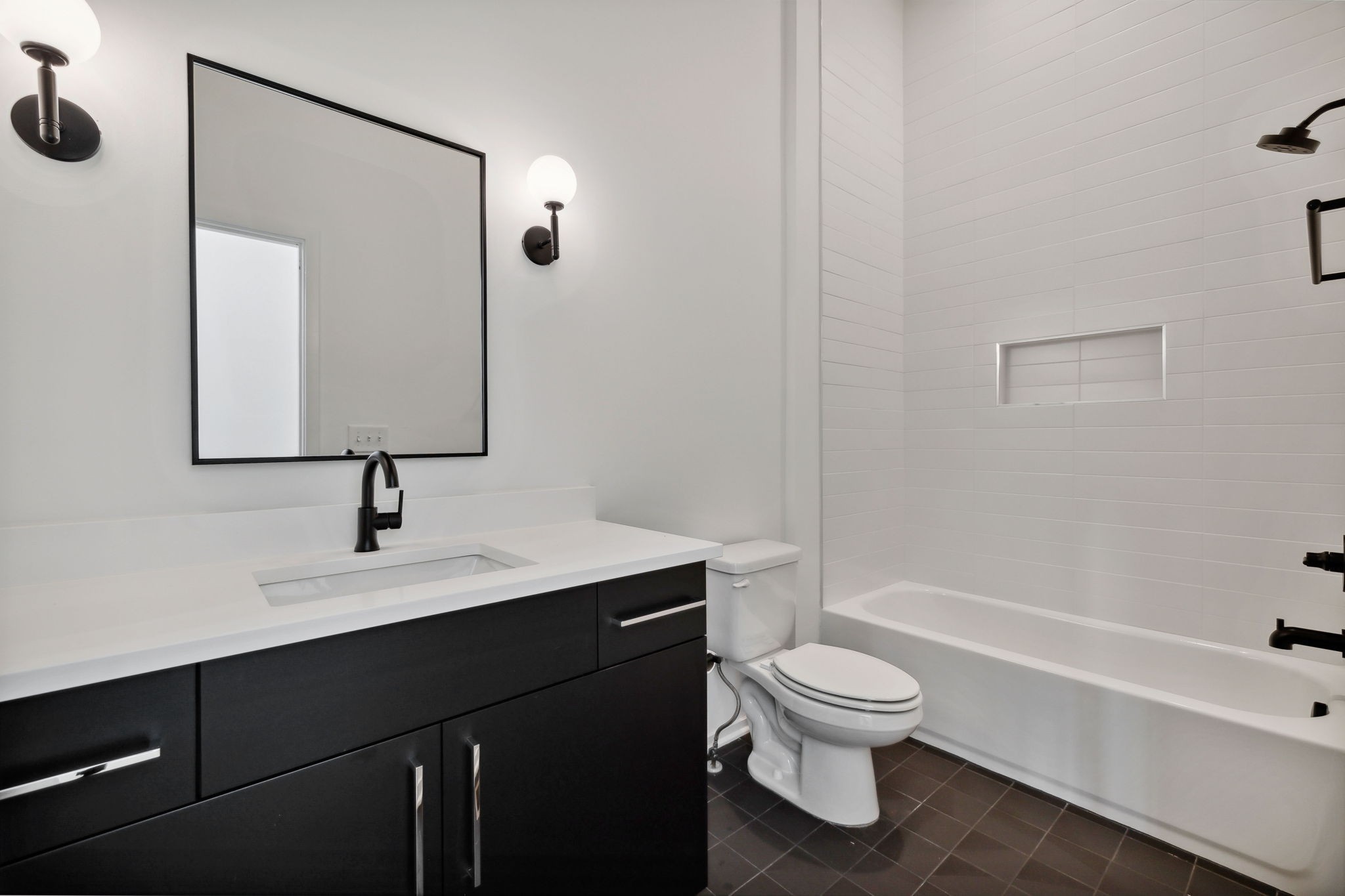 263 Riverside Drive, Unit A Nashville, TN 37206 - Photo 28 of 42 a bathroom with a toilet sink a mirror and shower