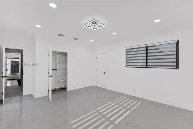 a view of a room with gym equipment and a chandelier