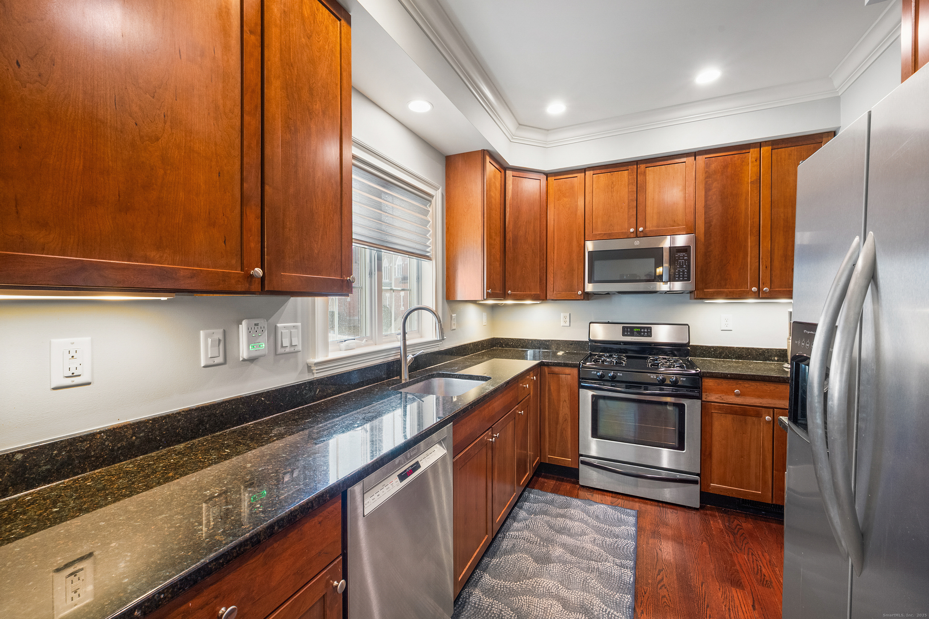 160 Glenbrook Road, Unit 6B Stamford, CT 06902 - Photo 2 of 19 a kitchen with stainless steel appliances granite countertop a stove a sink and a microwave