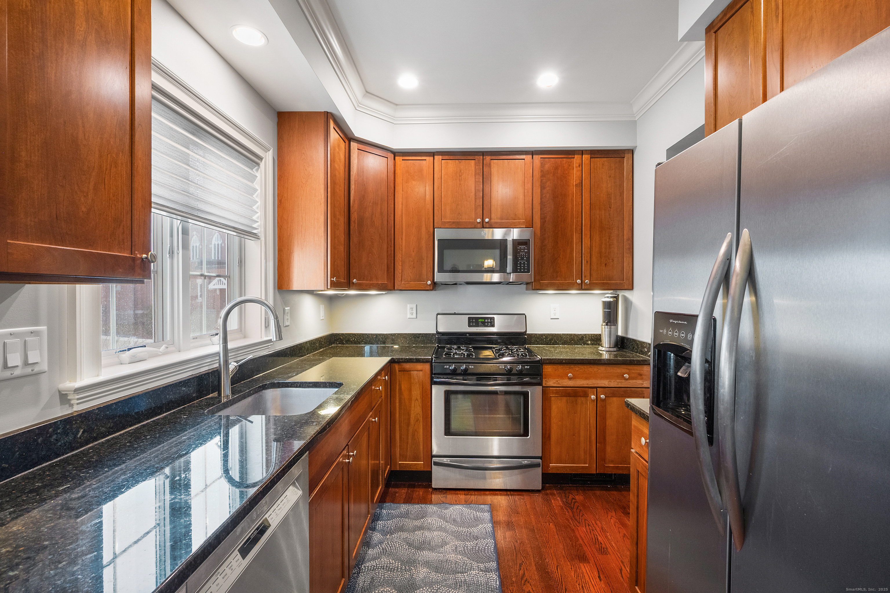 160 Glenbrook Road, Unit 6B Stamford, CT 06902 - Photo 3 of 19 a kitchen with stainless steel appliances granite countertop a sink a stove and a refrigerator