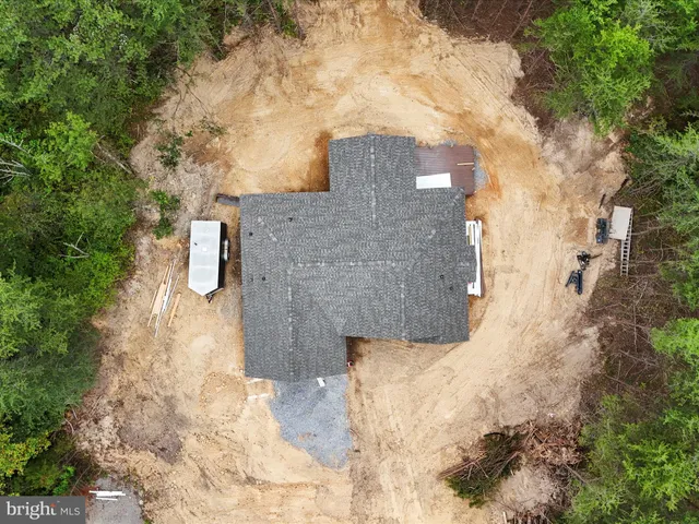 a brick building with a big yard of the house in the back