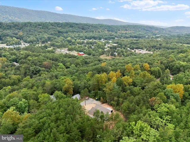 an aerial view of residential houses with outdoor and green space
