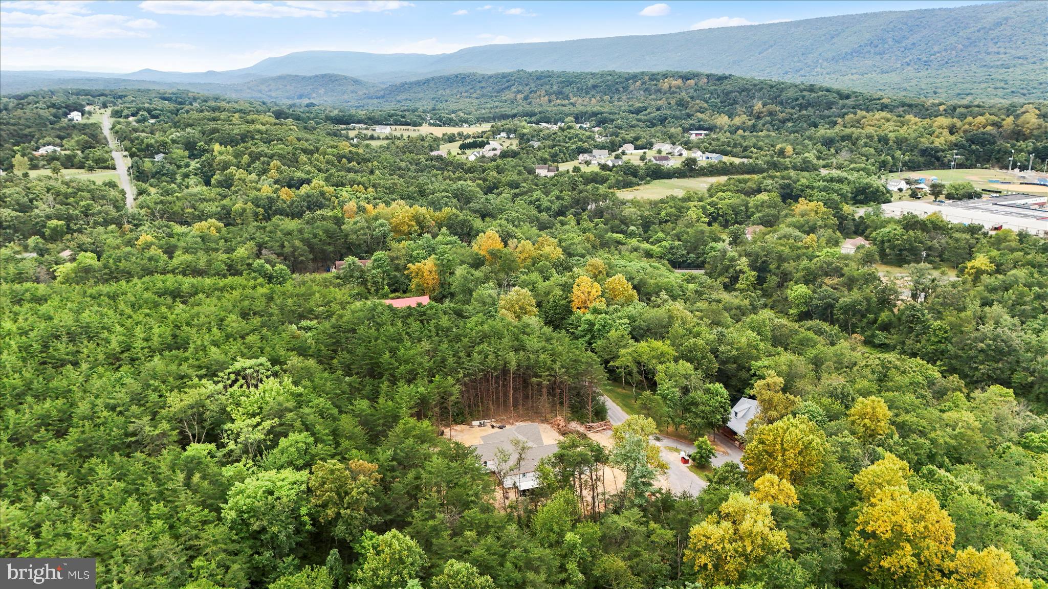 200 Wagon Trail Berkeley Springs, WV 25411 - Photo 27 of 53 a view of a green yard with an outdoor seating and trees