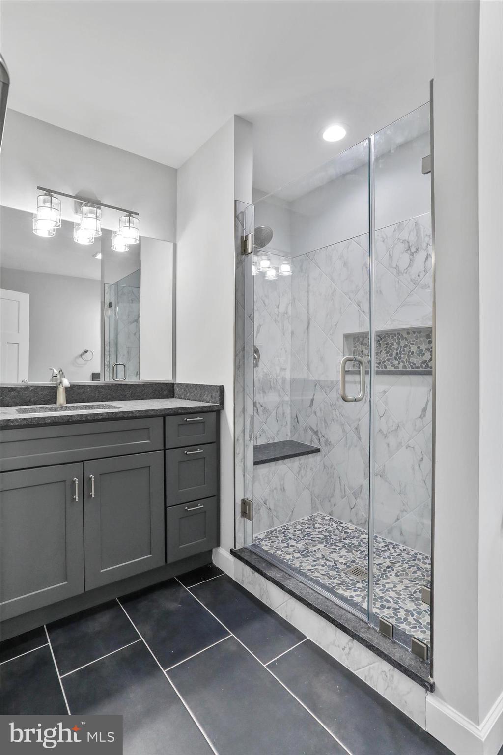 200 Wagon Trail Berkeley Springs, WV 25411 - Photo 31 of 53 a bathroom with a shower sink and mirror