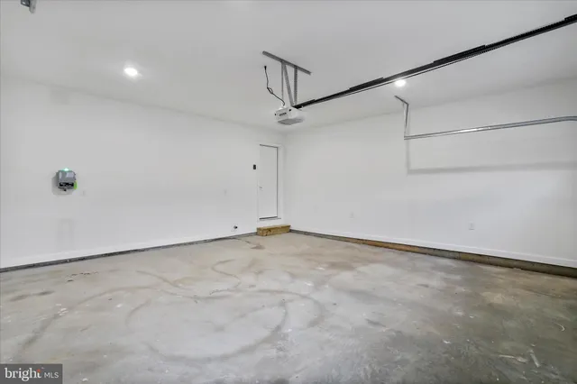an empty room with a window and a ceiling fan