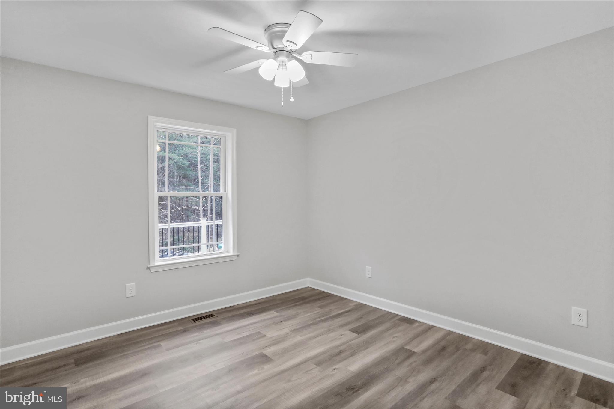 200 Wagon Trail Berkeley Springs, WV 25411 - Photo 35 of 53 an empty room with a window and a ceiling fan