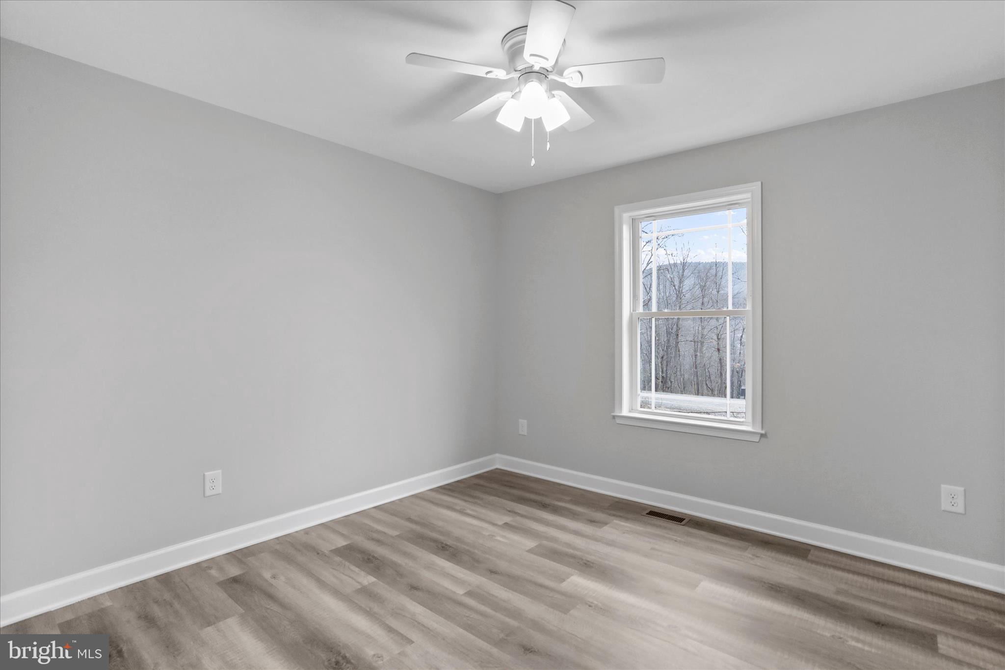 200 Wagon Trail Berkeley Springs, WV 25411 - Photo 40 of 53 an empty room with a window and a fan