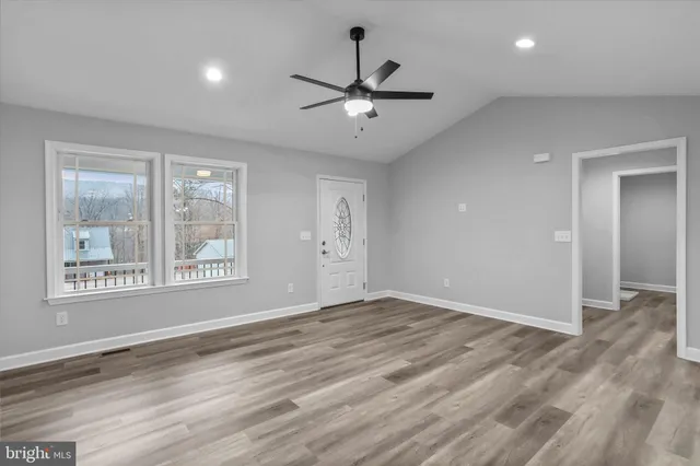 wooden floor in an empty room with a window