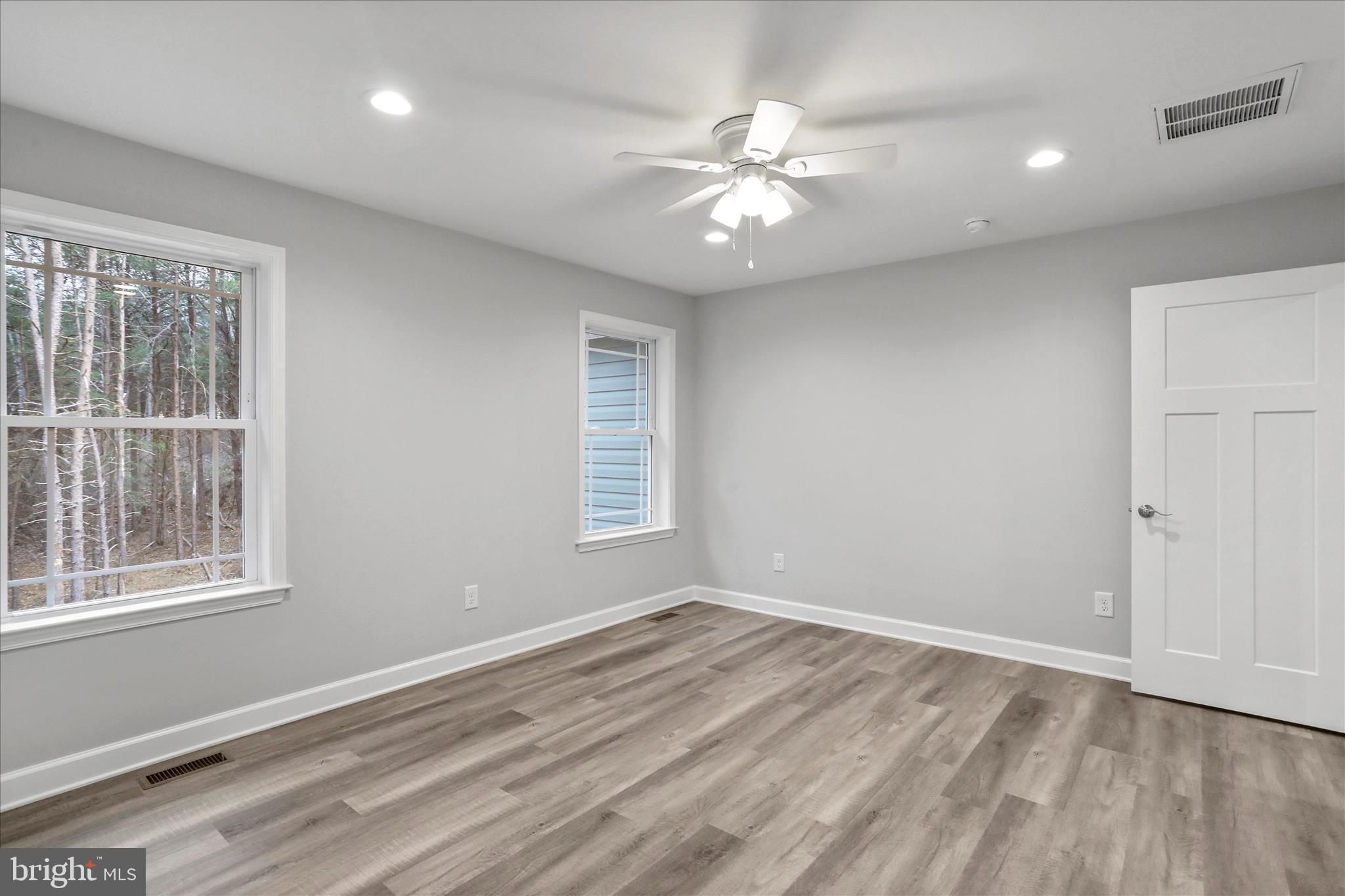 200 Wagon Trail Berkeley Springs, WV 25411 - Photo 51 of 53 a view of an empty room with wooden floor and a window