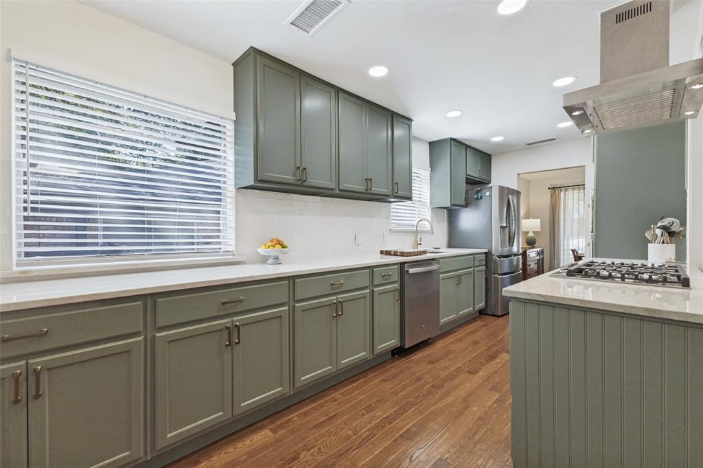 9864 Shoreview Road Dallas, TX 75238 - Photo 11 of 24 Kitchen featuring sage cabinetry, wood-finish flooring, recessed lighting, white countertops, and stainless steel appliances
