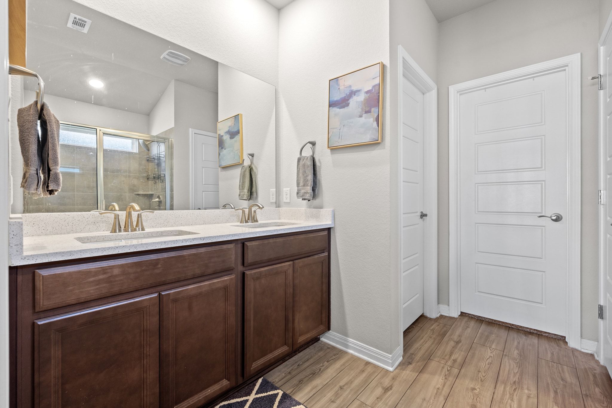 2856 Moyer Lane Round Rock, TX 78665 - Photo 12 of 27 Bathroom with double vanity, a shower stall, and light wood-style flooring