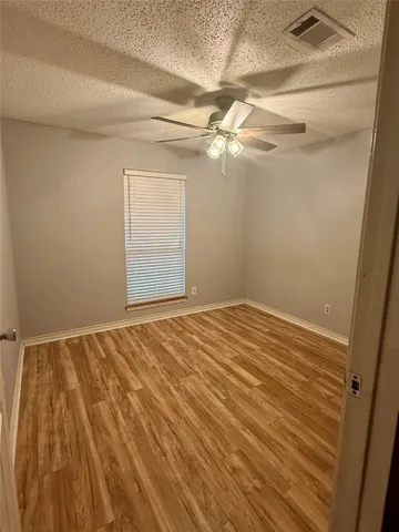a view of a livingroom with an empty space and a window