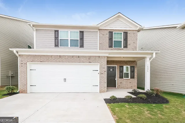 a front view of a house with garage