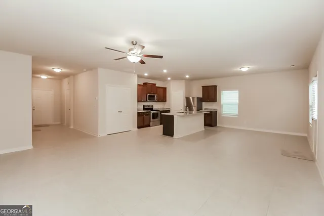 a kitchen with stainless steel appliances granite countertop a stove a sink and a refrigerator