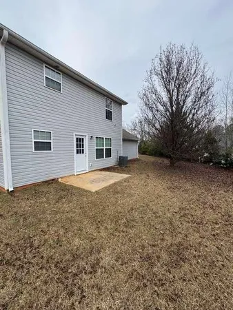 a view of a house with a backyard