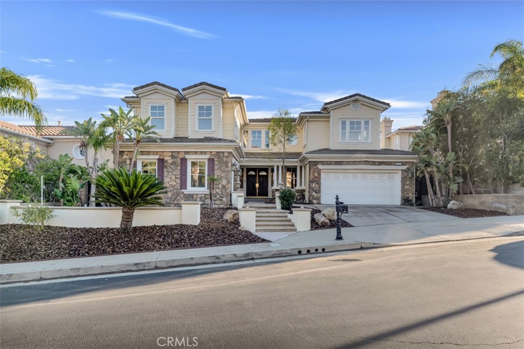 20212 Vía Medici Porter Ranch, CA 91326 - Photo 1 of 61 a front view of a house with garden