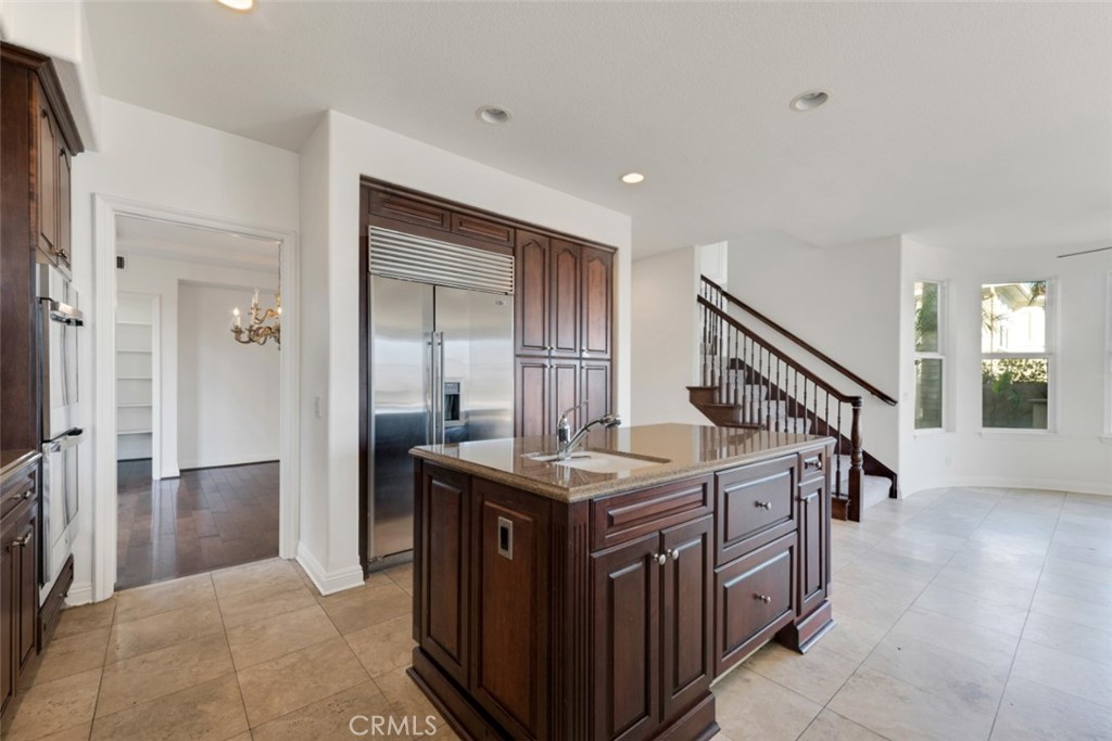 20212 Vía Medici Porter Ranch, CA 91326 - Photo 12 of 61 a kitchen that has a lot of cabinets in it