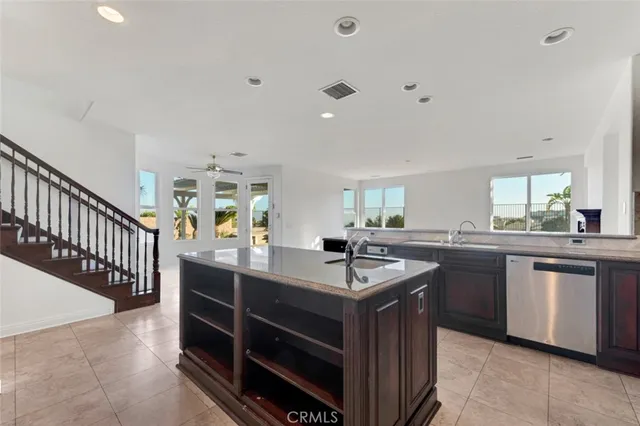 a kitchen with a sink a stove and cabinets