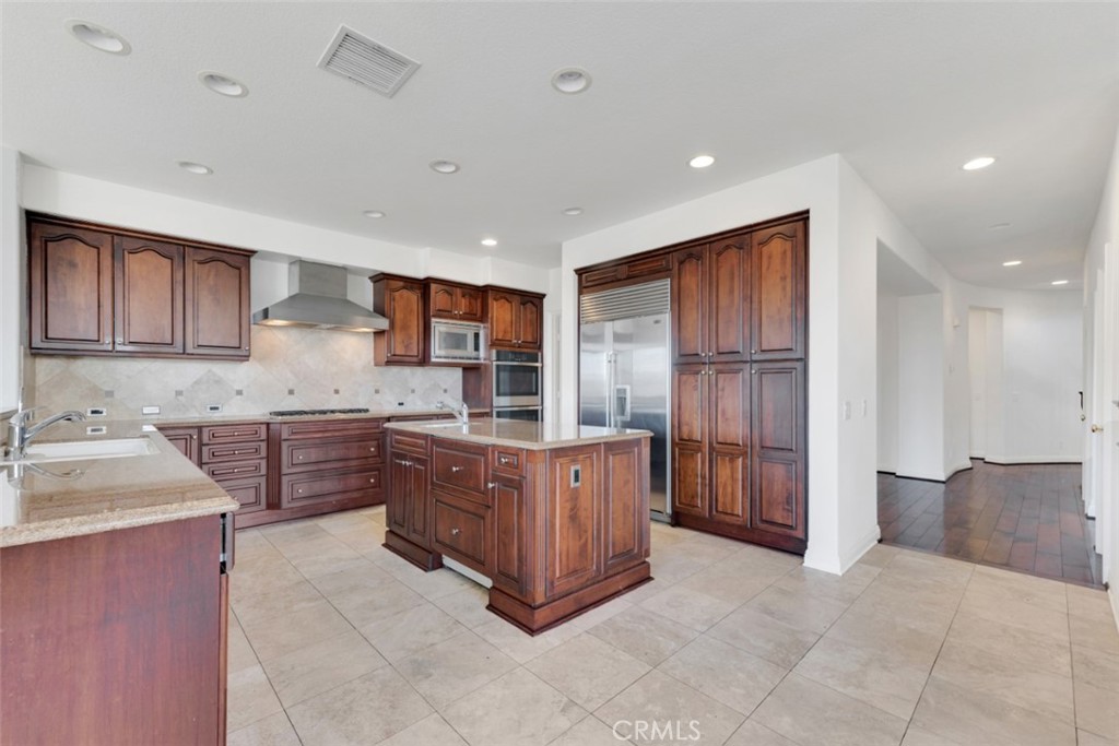20212 Vía Medici Porter Ranch, CA 91326 - Photo 16 of 61 a kitchen with stainless steel appliances granite countertop a refrigerator and a stove top oven