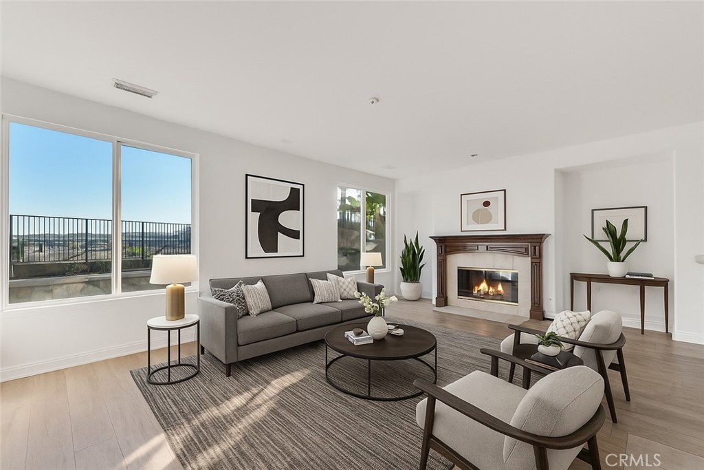 20212 Vía Medici Porter Ranch, CA 91326 - Photo 18 of 61 a living room with furniture and a fireplace