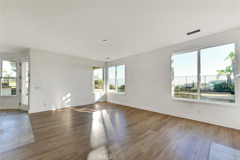 20212 Vía Medici Porter Ranch, CA 91326 - Photo 20 of 61 an empty room with wooden floor and windows