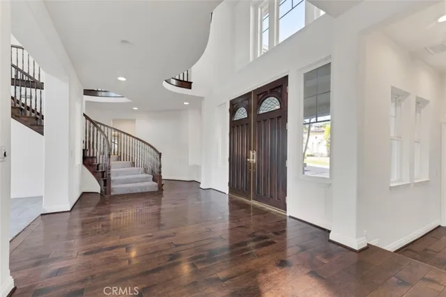 a view of an entryway with wooden floor