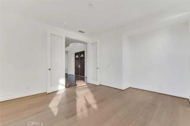 an empty room with windows and closet