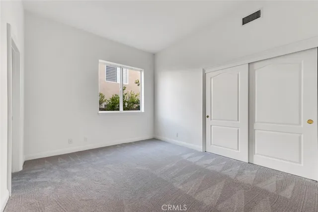 a view of an empty room and closet area