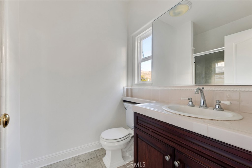 20212 Vía Medici Porter Ranch, CA 91326 - Photo 25 of 61 a bathroom with a sink toilet and mirror
