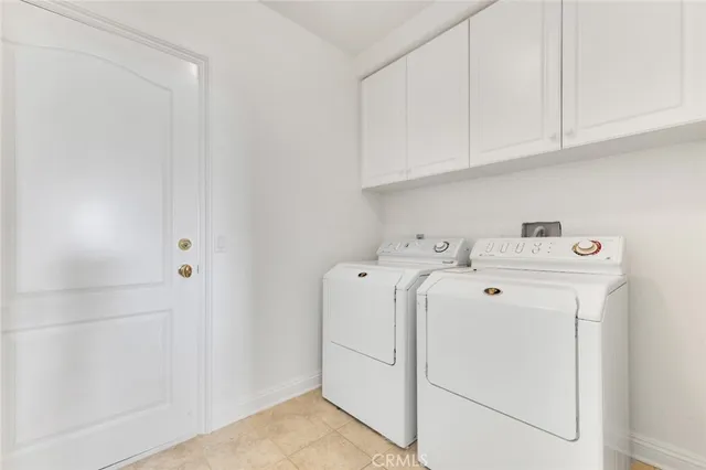 a view of a hallway with wooden floor and a potted plant