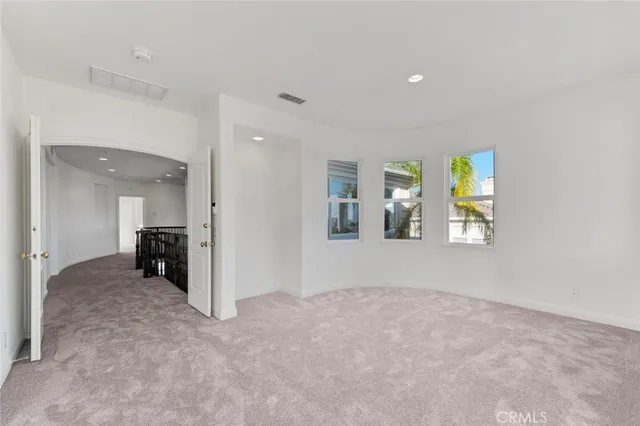 a spacious bathroom with a tub double sink and two mirror